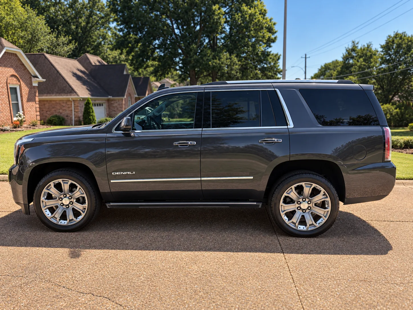 A full-size GMC Denali SUV detailed to a deep gloss on a driveway