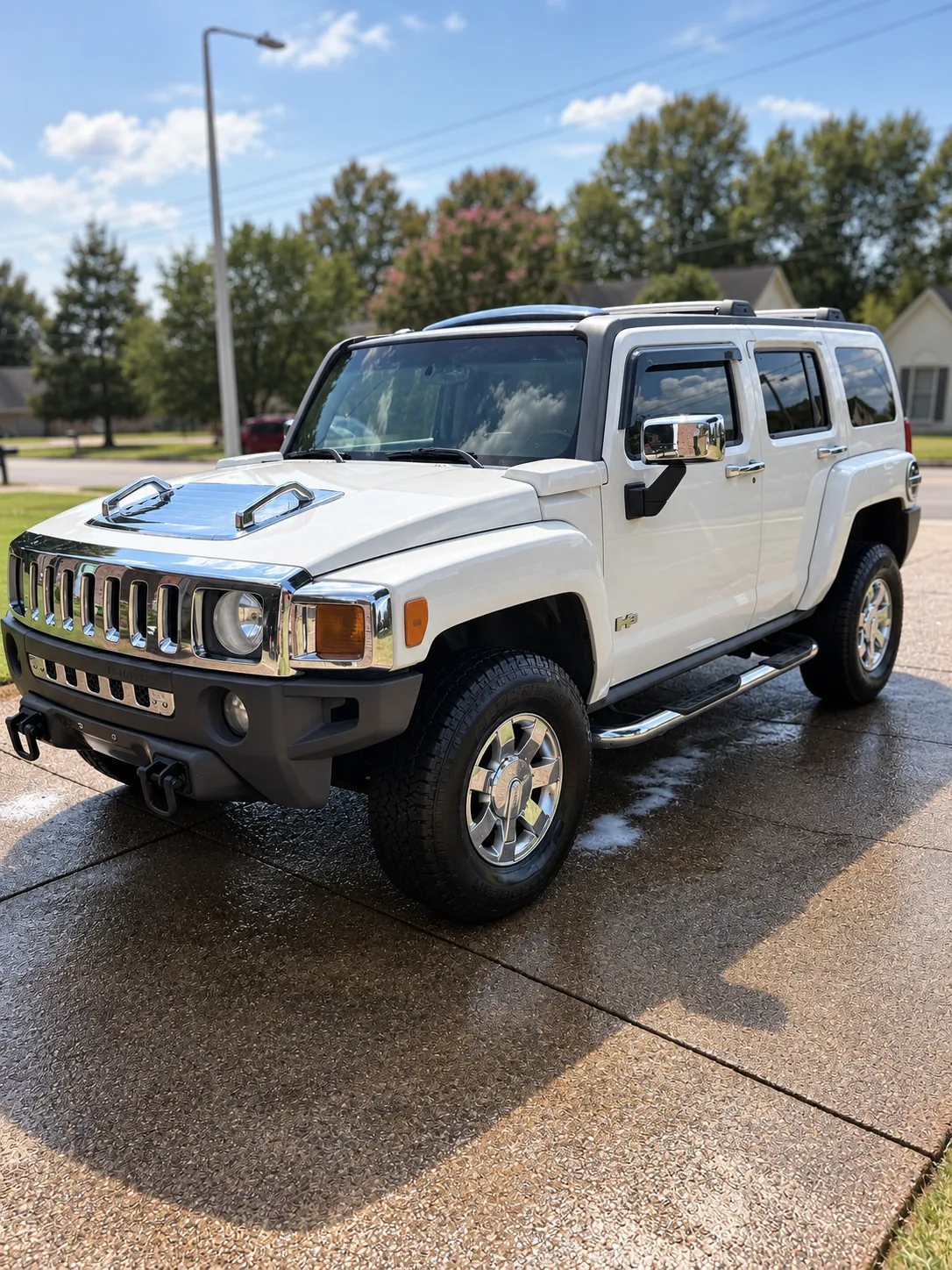 A white Hummer H3 after a full exterior detail on a driveway