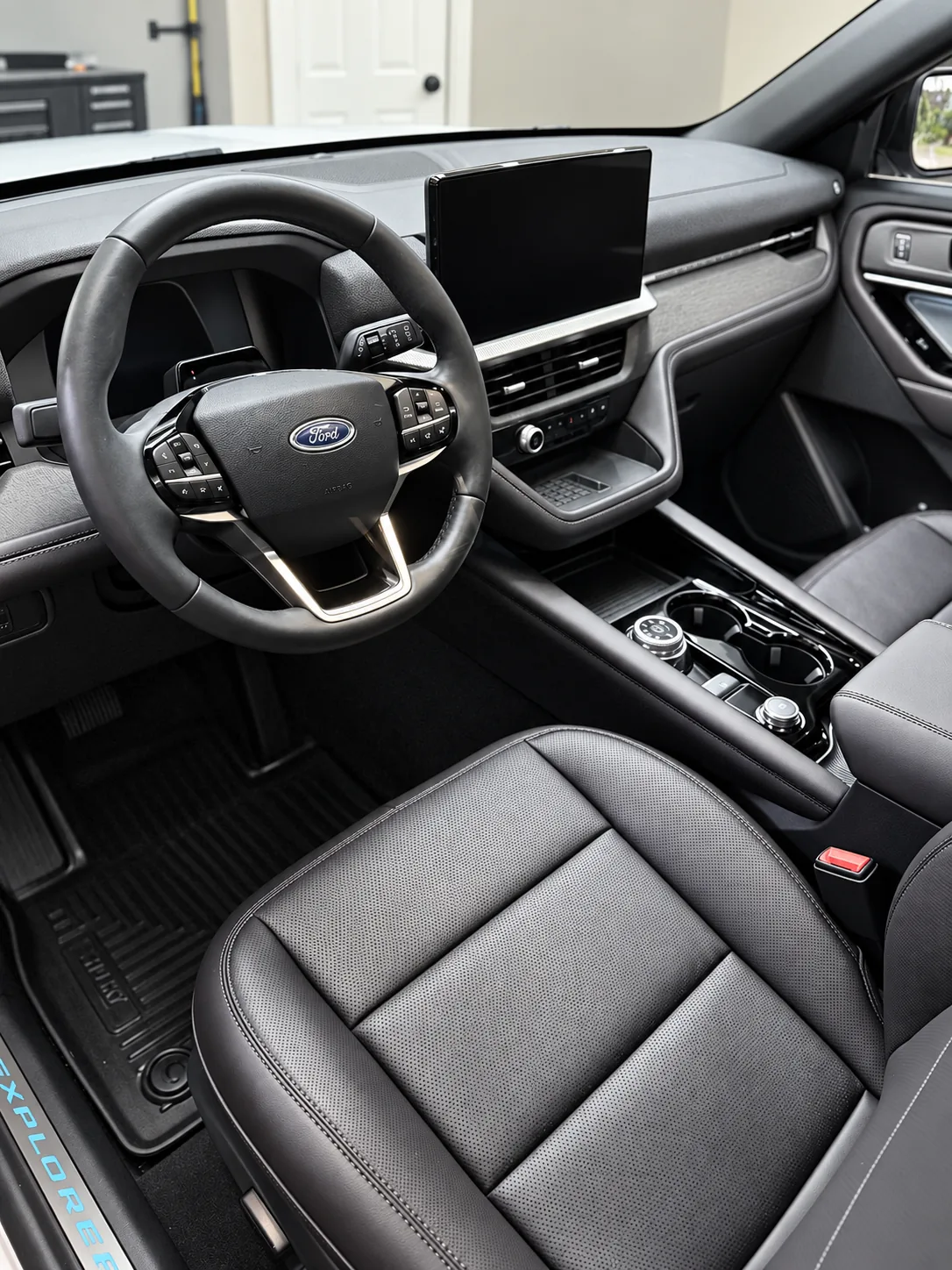 A Ford Explorer front cockpit with cleaned black leather seats and dashboard