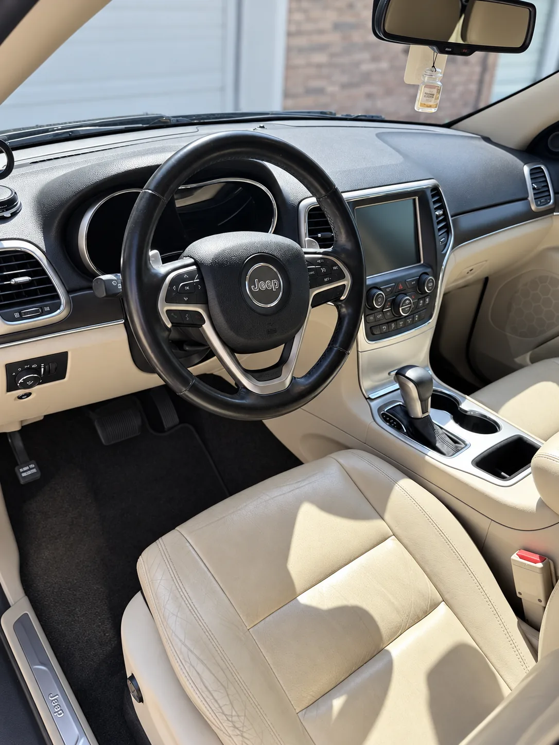 A Jeep interior with freshly cleaned black leather front seats